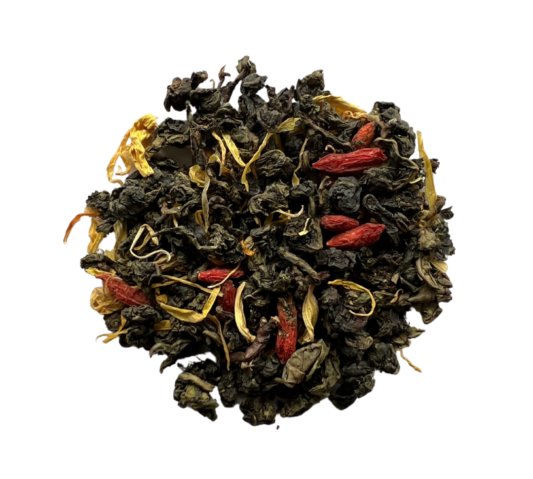 A close-up of dried tea leaves with pieces of watermelon and floral petals visible.