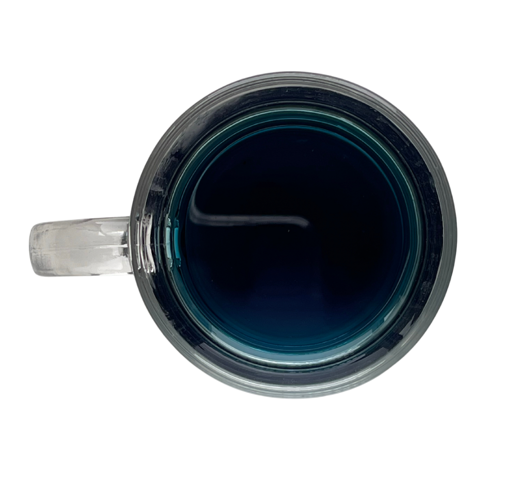 Paradise Tea in a glass teacup, vibrant blue color