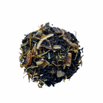 A close-up of Black Lemon tea leaves, showing black tea leaves interspersed with pieces of lemon and lime, and yellowish-brown lemongrass leaves.