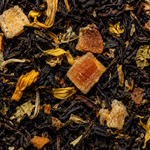 Close-up of black tea leaves with ginger pieces and dried herbs