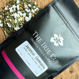 Black package of 'The Irie Cup' with a label on a wooden surface