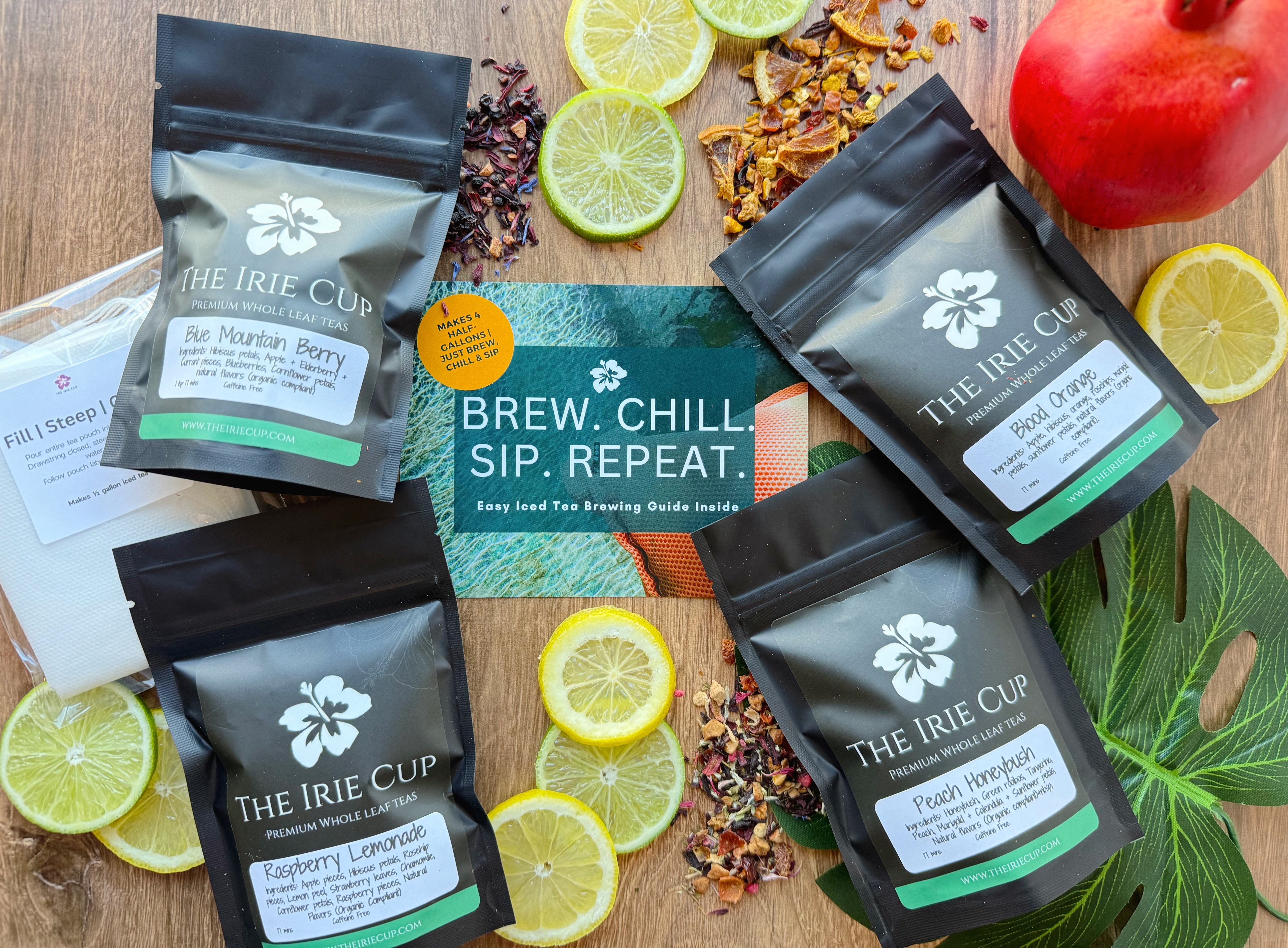Multiple packaged tea bags from 'The Irie Cup' displayed on a wooden surface with fruits and tea leaves around them, indicating flavors like peach, lemon, and berry.
