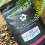 Tea packaging with visible brand name and tea leaves on a wooden surface