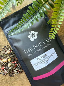 Tea packaging with visible brand name and tea leaves on a wooden surface