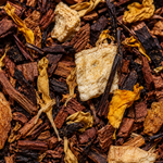 Close-up of dried tea leaves and herbs with a focus on texture and color.
