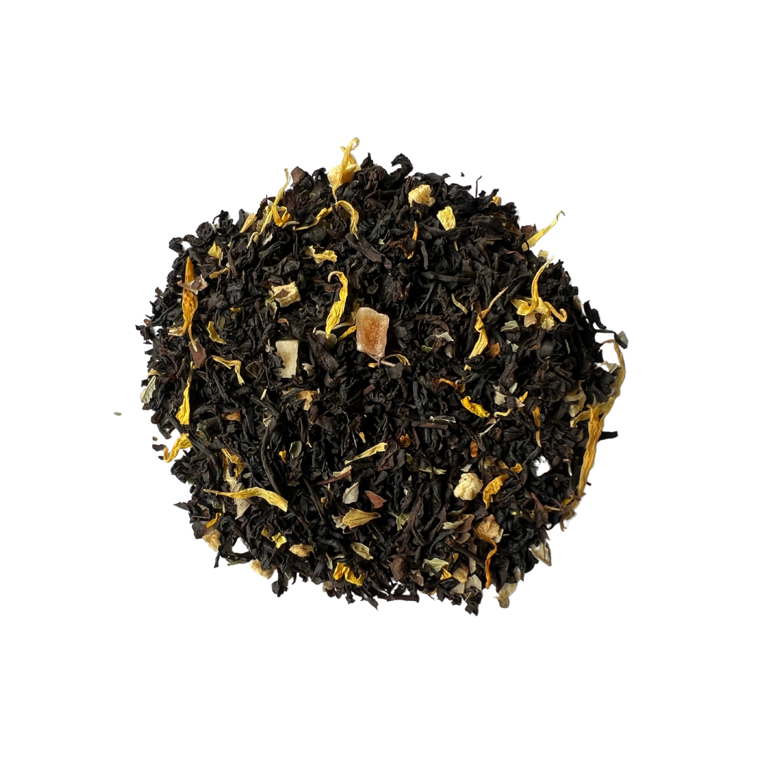 A pile of black tea leaves with pieces of apricot and petals of calendula and sunflower mixed in.