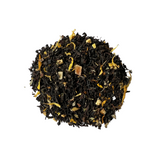 A pile of black tea leaves with pieces of apricot and petals of calendula and sunflower mixed in.