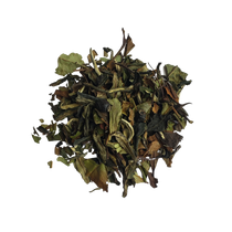 A pile of loose leaf tea mix with visible natural ingredients, likely to be used for making a cup of tea.