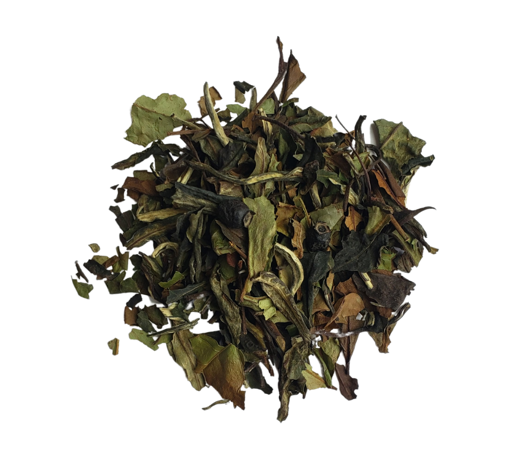 A pile of loose leaf tea mix with visible natural ingredients, likely to be used for making a cup of tea.