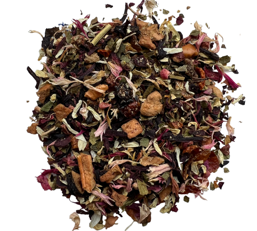 A variety of dried tea leaves and natural flavorings including apple pieces, hibiscus petals, rosehips, lemon peel, and raspberry pieces.