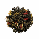 A close-up of dried tea leaves with pieces of watermelon and floral petals visible.