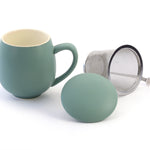 A teal porcelain mug with a stainless steel strainer and a matching porcelain lid, displayed against a white background.