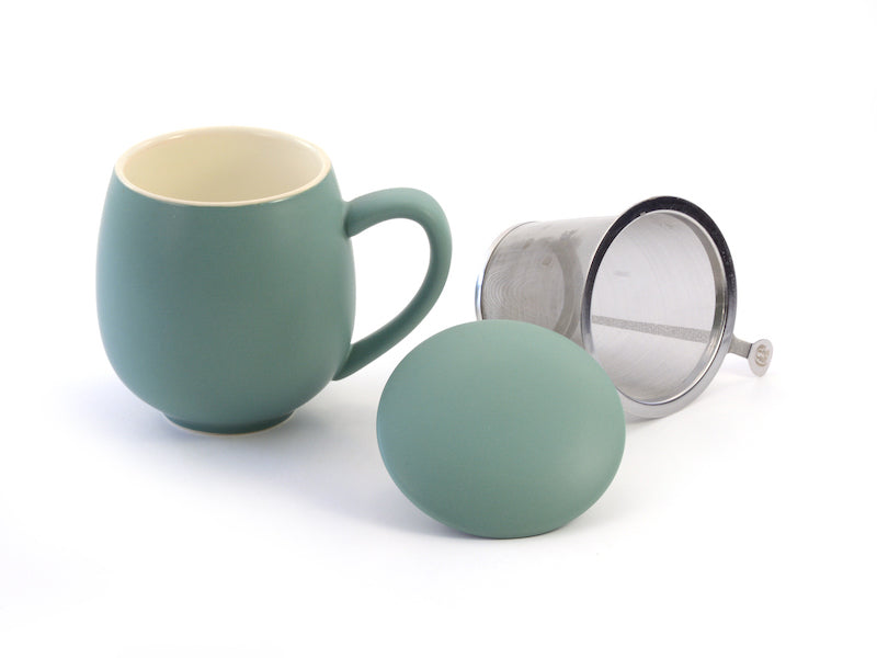 A teal porcelain mug with a stainless steel strainer and a matching porcelain lid, displayed against a white background.